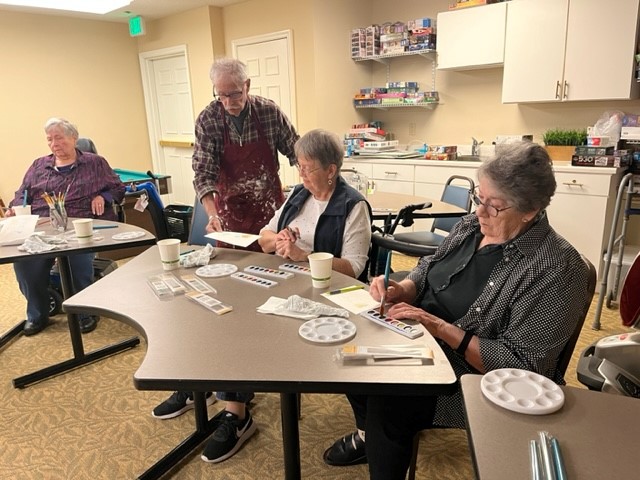 Residents at Cottage Grove Place take part in a painting workshop as a part of the Creative Arts Group.