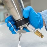 James Byrne demonstrates use of a whipping siphon to dispense gas-entrapping foam in his lab.