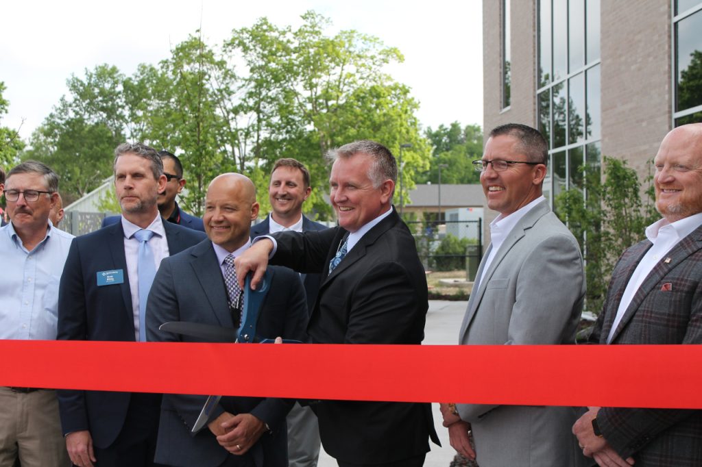 North Liberty Mayor Chris Hoffman prepares to cut the ribbon during the grand opening ceremony of City Hall.