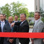 North Liberty Mayor Chris Hoffman prepares to cut the ribbon during the grand opening ceremony of City Hall.