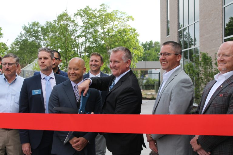 North Liberty Mayor Chris Hoffman prepares to cut the ribbon during the grand opening ceremony of City Hall.