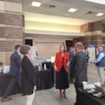 Iowa Gov. Kim Reynolds, center, greets members of the Iowa Association of Business & Industry in the Davenport RiverCenter Great Hall before speaking at ABI’s 2024 Taking Care of Business Conference. CREDIT KENDA BURROWS