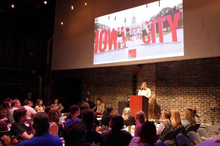 Iowa City Downtown District's executive director, Betsy Potter, takes the podium at the Englert Theatre for the 2024 State of the Downtown, June 5.