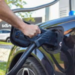 An EV owner plugs his vehicle into a charging station at McGrath Kia, 1020 N Center Point Rd., Hiawatha.