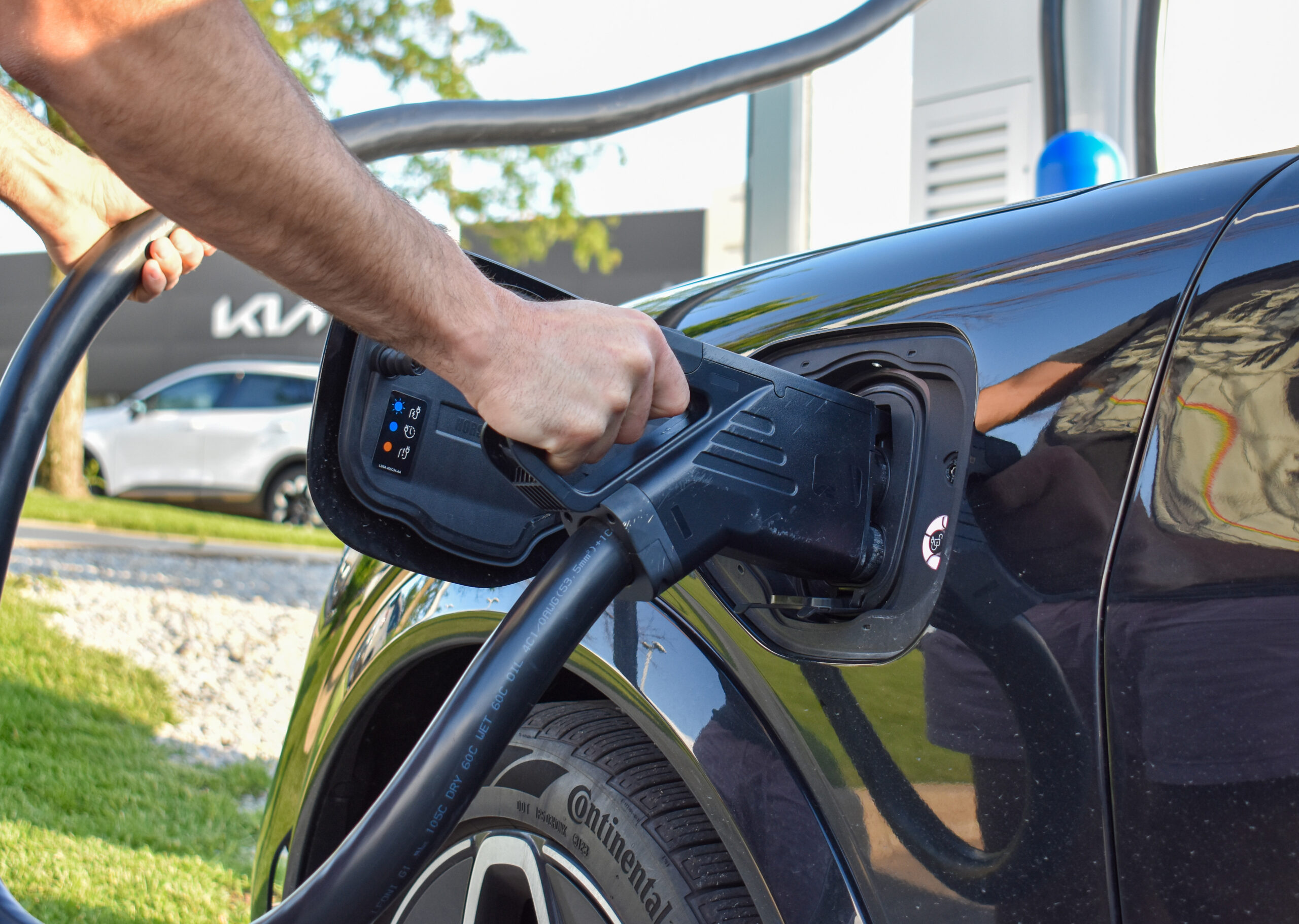 DSC_0621 An EV owner plugs his vehicle into a charging station at McGrath Kia, 1020 N Center Point Rd., Hiawatha.