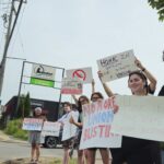Bruegger's Bagels employees picket outside the franchise's South Riverside Drive location on June 15, 2024, in Iowa City. union