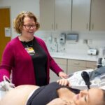 Andrea Greiner, division director of the maternal-fetal medicine division in the UIHC's Department of Obstetrics and Gynecology, performs an ultrasound on a patient.