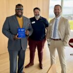Bruce Teague, CEO and owner of Caring Hands & More and the mayor of Iowa City, accepts the SBA Impact Award June 11 in Des Moines. (from left) Bruce Teague, Chamber member Paul Richardson and Chamber chair Dan Jansen.