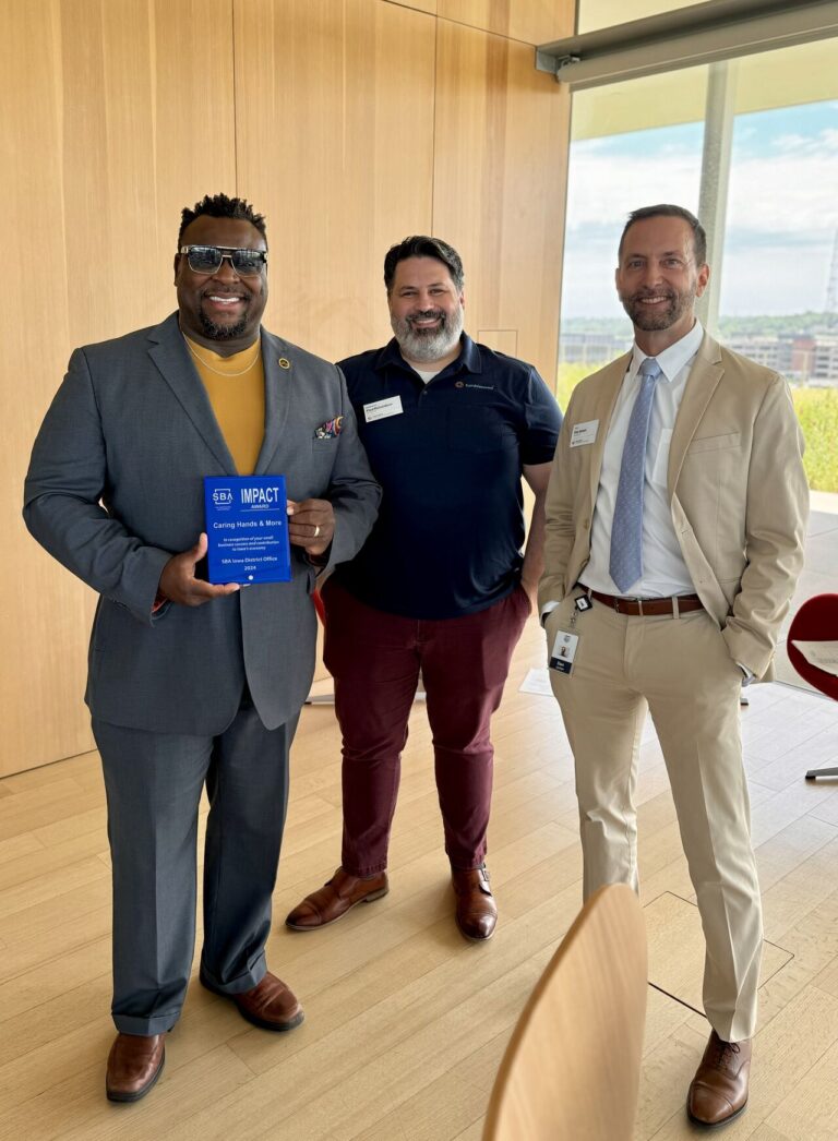 Bruce Teague, CEO and owner of Caring Hands & More and the mayor of Iowa City, accepts the SBA Impact Award June 11 in Des Moines. (from left) Bruce Teague, Chamber member Paul Richardson and Chamber chair Dan Jansen.