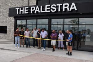 The Palestra co-owners Dave Lane and Brandon Prat prepare to cut the ribbon at the building's entrance July 9.