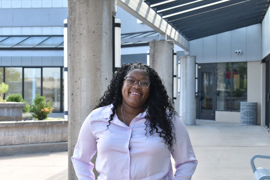 Tasha Lard stands outside the South District Market in Iowa City Aug. 21.