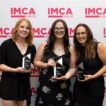 UFG Senior Marketing Project Manager Andrea Lewis, Digital Marketing Specialist Erin Glenn and Marketing PM Manager Alissa Carson accept IMCA Showcase Awards on behalf of the UFG Insurance corporate marketing team.