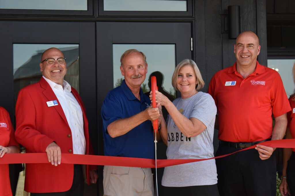 Dan and Judy Lubben, along with ambassadors from the Marion Chamber of Commerce, celebrate the opening of the new location of Lubben Vineyards & Wines on Sept. 12 in Anamosa.