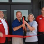 Dan and Judy Lubben, along with ambassadors from the Marion Chamber of Commerce, celebrate the opening of the new location of Lubben Vineyards & Wines on Sept. 12 in Anamosa.