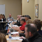 Attendees look over hand-outs documenting data and trends for the Kirkwood Benton County Center.