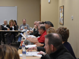 Attendees look over hand-outs documenting data and trends for the Kirkwood Benton County Center.