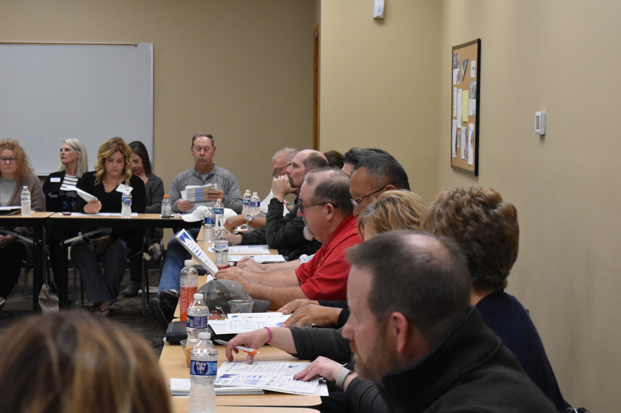 Attendees look over hand-outs documenting data and trends for the Kirkwood Benton County Center.