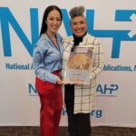Evelyn Castro (left), secretary of National Association of Hispanic Publications (NAHP), presents Erica Macias with the Latina Publisher of the Year award.