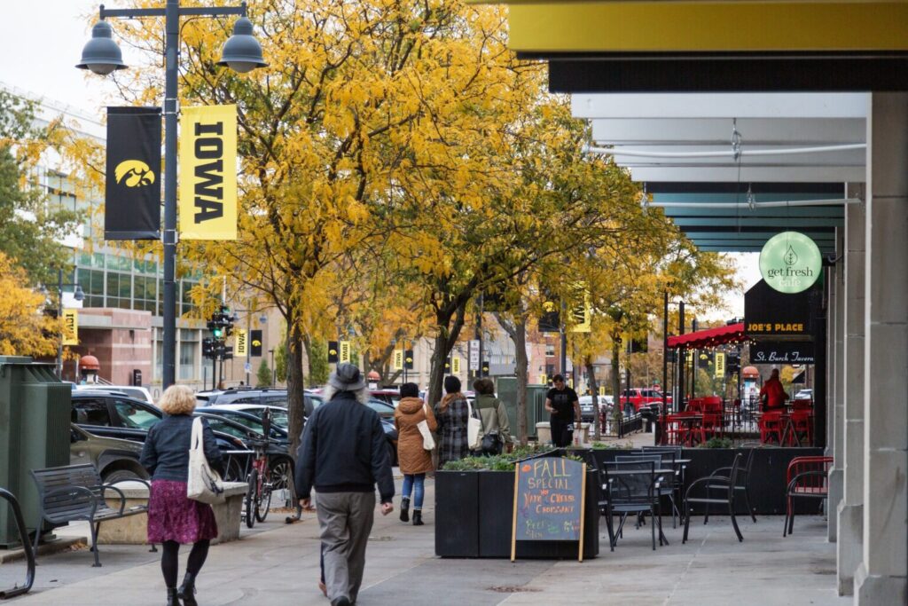 Pedestrians line the sidewalk on E. Iowa Avenue in Iowa City.