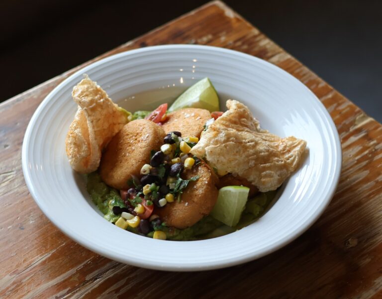 Wilson Orchard & Farm's Iowa City summer menu features the Heirloom Masa Arepas. Made with creamy Queso Oaxaca, fresh sweet corn, and a savory black bean criolla, and topped with crispy pork chicharrones. Wilson's Iowa City location will host the first dinner in a series of farm-to-table events put on by The Iowa Tourism Office and Choose Iowa have partnered with the Iowa Restaurant Association.