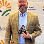 Todd Patterson, CEO of Washington County Hospitals and Clinics, poses with the Top 20 Critical Access Hospital award at the National Rural Health Association’s Critical Access Hospital Conference in September.