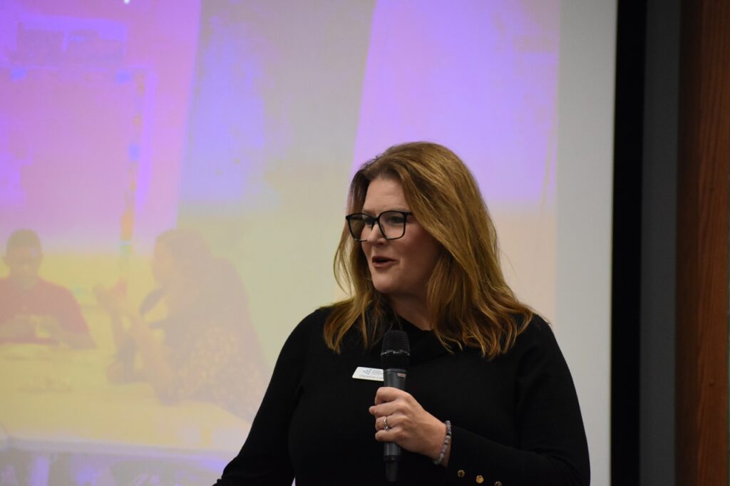 Christine Landa, president of Junior Achievement of Eastern Iowa, addresses a room of local business and education leaders.
