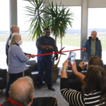 Mayor Bruce Teague and members of the Airport Commission (Ryan Story, Judy Pfohl, and Warren Bishop) at a ribbon cutting ceremony at the Iowa City Municipal Airport on Thursday, Nov. 14, 2024.