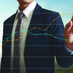 Hand touching a graphs of financial indicator and accounting market