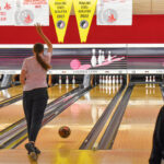 A Colonial Lanes patron watches the bowling ball she just released glide toward the pins on the bowling lane. Despite renovations going on, business has not slowed down for the bowling center. CREDIT ANNIE SMITH BARKALOW