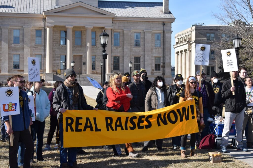 Members of UI's graduate student worker union COGS gather Wednesday outside the Pentacrest. Wages are not keeping step with inflation and are not sustainable, they say.