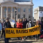 Members of UI's graduate student worker union COGS gather Wednesday outside the Pentacrest. Wages are not keeping step with inflation and are not sustainable, they say.