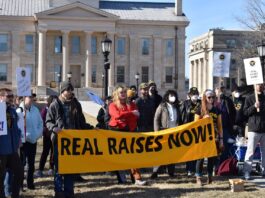 Members of UI's graduate student worker union COGS gather Wednesday outside the Pentacrest. Wages are not keeping step with inflation and are not sustainable, they say.