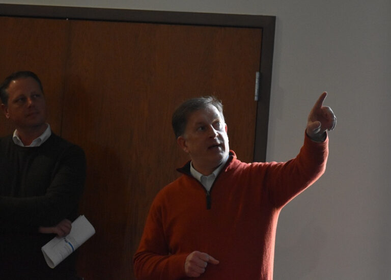 Coralville city engineer Scott Larson points to slides exhibiting current infrastructure projects happening within the city. Mr. Larson was on hand to provide updates on Gather Iowa to community stakeholders at the Coralville City Hall March 3.