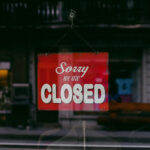 A red sign reading "Sorry we're closed" hangs in a window.