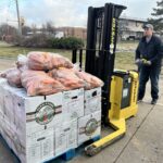 A Field to Family volunteer readies a pallet of fresh produce for delivery to local schools in December. The food nonprofit says cuts to the LFS and LFPA programs will hurt its ability to provide access to local food and education for those who need it most.