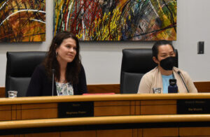 Coralville Mayor Meghann Foster (left) and council member Hai Huynh listen to Mark Kaufman during the council's May 13 meeting.