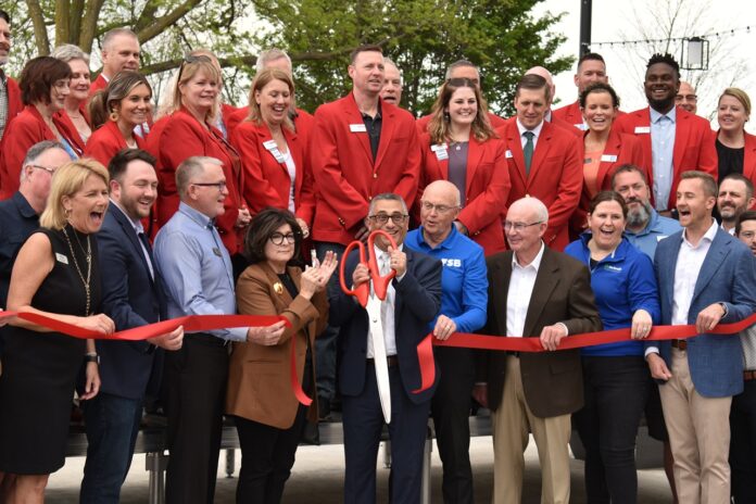 Marion Mayor Nick AbouAssaly (center) cuts the ribbon signifying the completion of Marion's Central Plaza project on Wednesday, May 7.