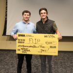 University of Iowa undergraduates Patrick Igo and Landon Stoll with FLIP hold a check for $1,000 at UI JPEC's Undergraduate Startup Incubator End of Semester Pitch Competition May 9.