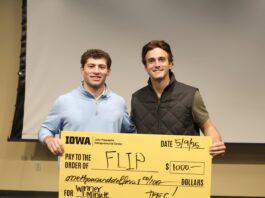 University of Iowa undergraduates Patrick Igo and Landon Stoll with FLIP hold a check for $1,000 at UI JPEC's Undergraduate Startup Incubator End of Semester Pitch Competition May 9.