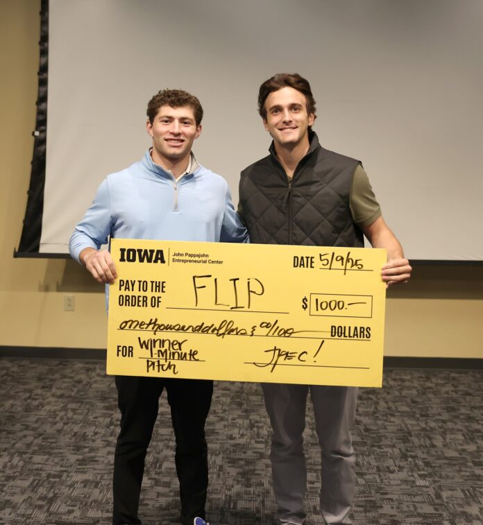 (Photo by Darren Miller) University of Iowa undergraduates Patrick Igo and Landon Stoll with FLIP hold a check for $1,000 at UI JPEC's Undergraduate Startup Incubator End of Semester Pitch Competition May 9.
