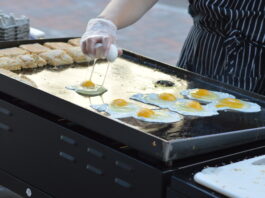 Eggs fry on the grill of Feedwell Kitchen & Bakery during a previous Downtown Farmers Market in Cedar Rapids. Farm-fresh eggs are expected to be in high demand at markets this year. CREDIT CINDY HADISH