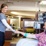A UI Health Care nurse with a patient.