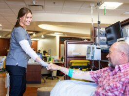 A UI Health Care nurse with a patient.