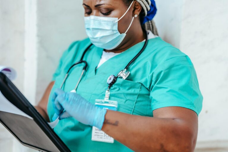 A nurse looks over her notes. health care workforce