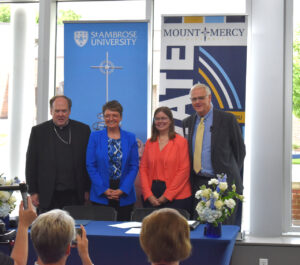 (From left) Bishop Dennis Walsh, of the Diocese of Davenport; St. Ambrose President Amy Novak; Julia Cavallo, executive director of Conference for Mercy Higher Education; and Mount Mercy President Todd Olson.