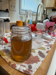 A mason jar of brown water from a kitchen tap at a Lake Ridge Estates home awaits testing in December 2024. 