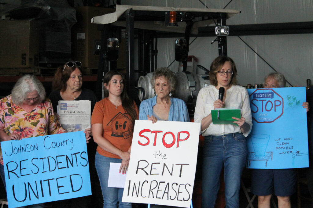Jennifer Sherer (right), director of the State Worker Power Initiative with the Economic Policy Institute, speaks during the Johnson County manufactured home park press conference June 18.