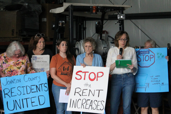 Jennifer Sherer (right), director of the State Worker Power Initiative with the Economic Policy Institute, speaks during the Johnson County manufactured home park press conference June 18.