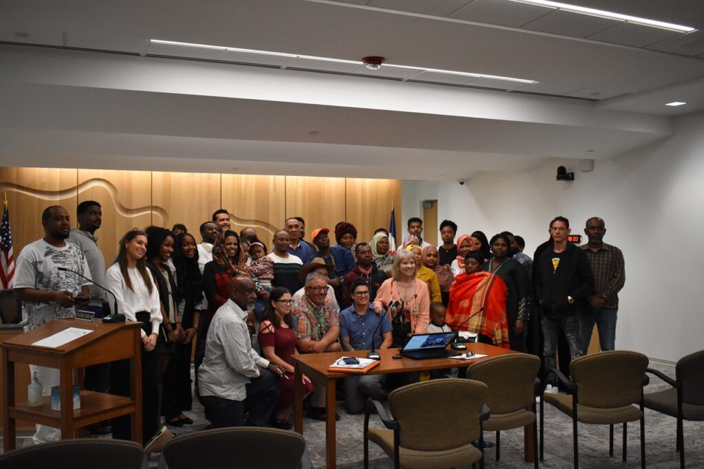 Audience members and presenters of the proposed immigrant welcome center pose with the Johnson County Board of Supervisors June 4, 2025.