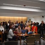 Audience members and presenters of the proposed immigrant welcome center pose with the Johnson County Board of Supervisors June 4, 2025.